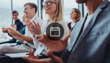 Employees at an event clapping