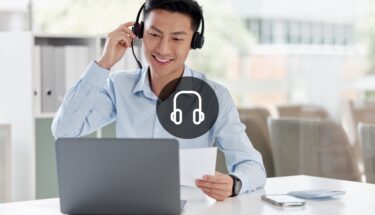 Man with headset looking at computer