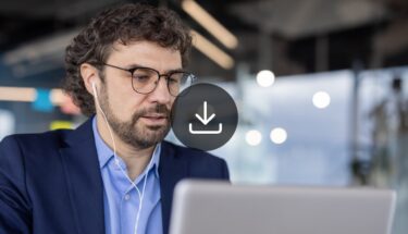 Man with glasses looking at computer screen