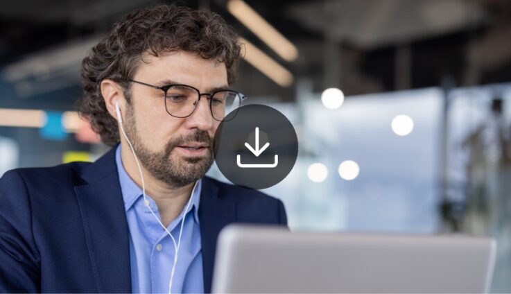 Man with glasses looking at computer screen