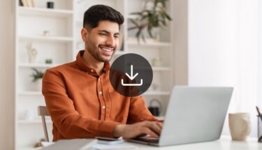 Man in business casual typing into laptop computer