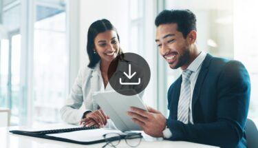 Image of two professional employees looking at a tablet.