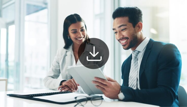 Image of two professional employees looking at a tablet.