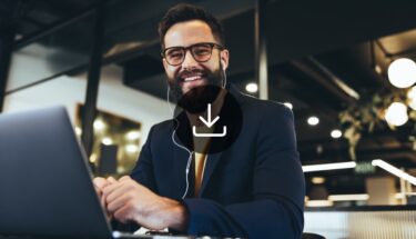 A man wearing earphones smiling