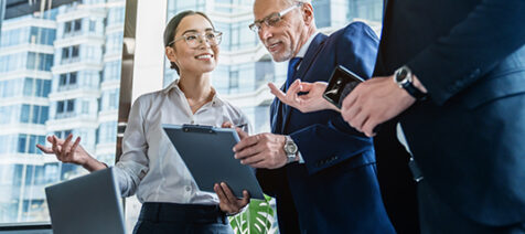 Business colleagues discussing over report document at work