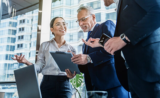 Business colleagues discussing over report document at work