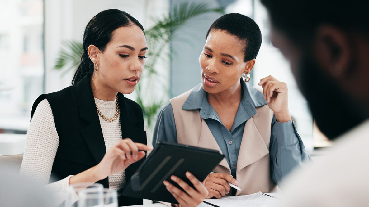 Two women looking at tablet screen