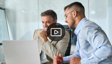 Two men looking at computer screen