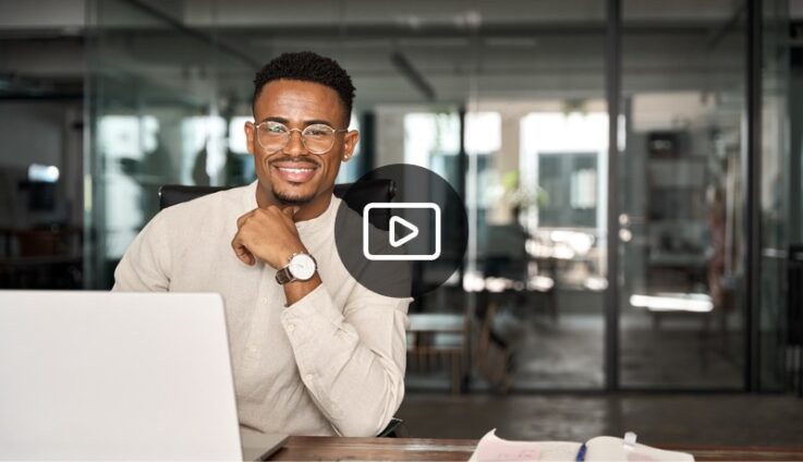 Man sitting on desk smiling