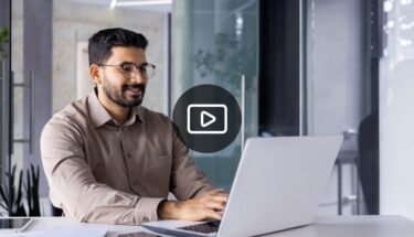 Man with glasses typing on computer