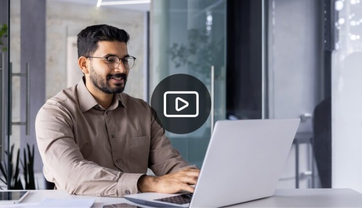 Man with glasses typing on computer