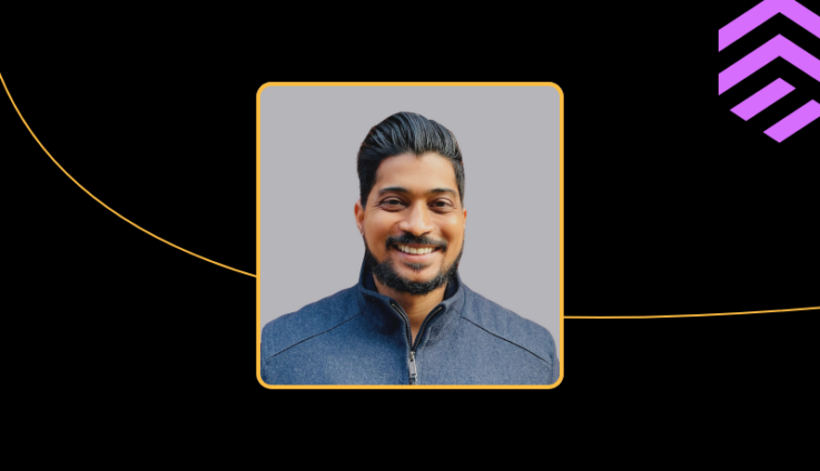 A professional headshot of Milind Khandare, smiling slightly and wearing a dark suit jacket.