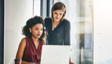 Two women looking at laptop computer screen