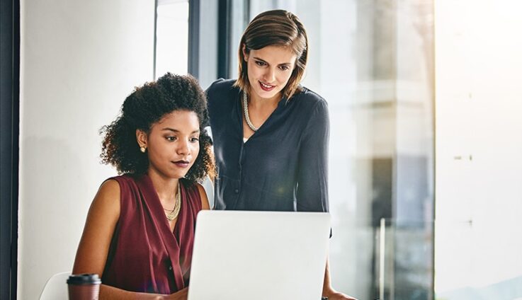 Two women looking at laptop computer screen