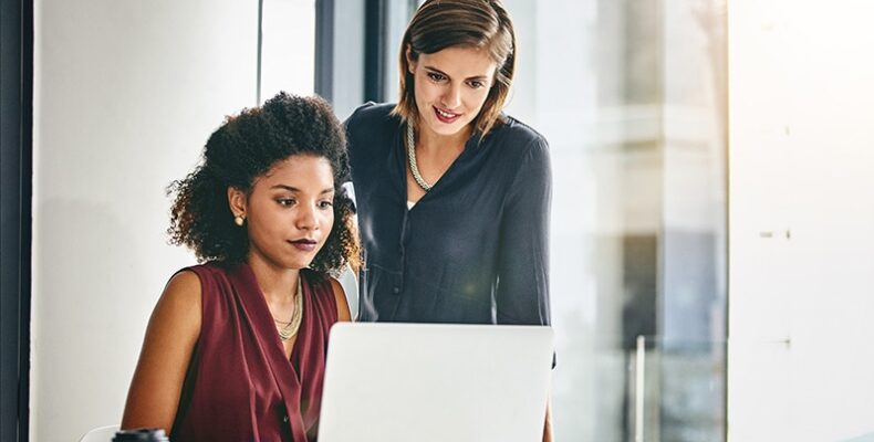 Two women looking at laptop computer screen