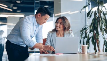 Woman and man looking at computer