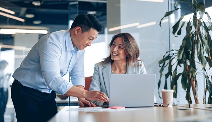 Woman and man looking at computer