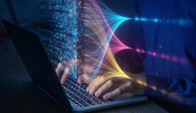 A person typing in a laptop computer