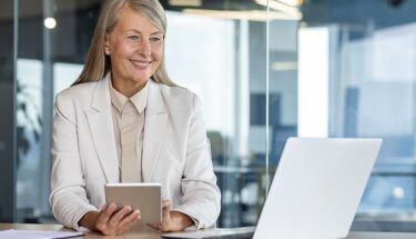 A woman with white suit sitting down