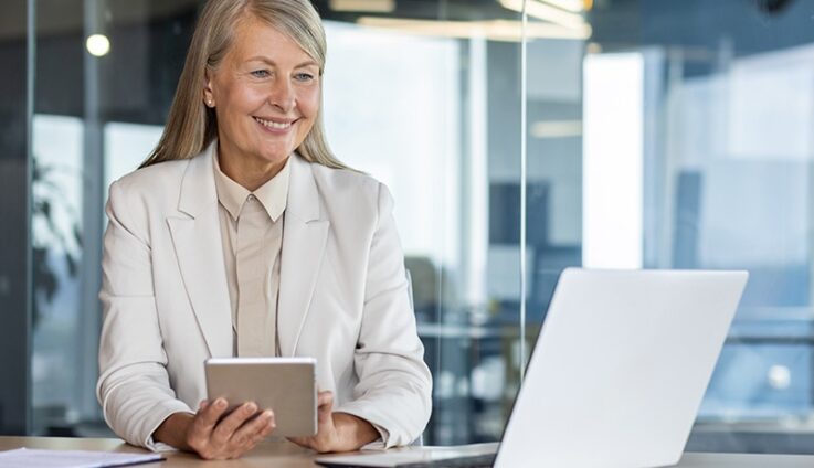 A woman with white suit sitting down