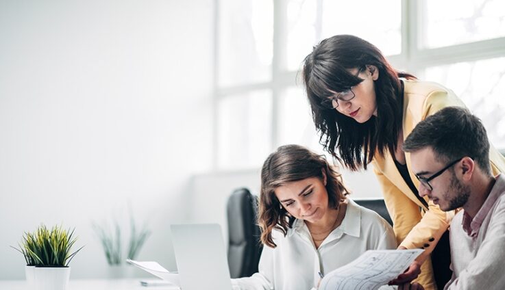 Three people in office setting