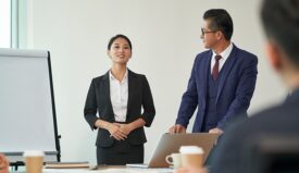 Professionally dressed woman giving a presentation in office setting