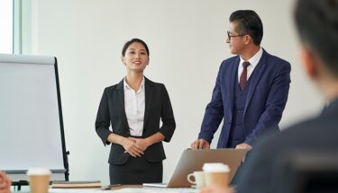 Professionally dressed woman giving a presentation in office setting