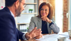 A woman and man speaking with each other in an office setting