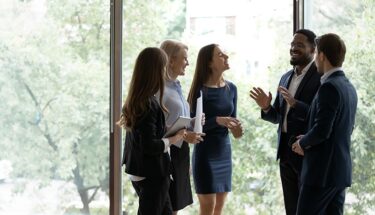 Group of professionals speaking with each other
