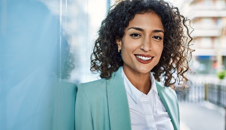 Professionally dressed woman smiling