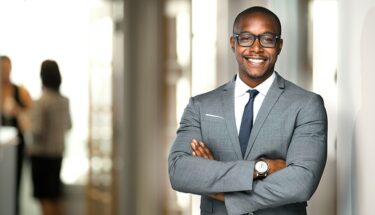 Man in suit crossing arms